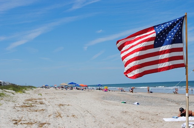 American flag on busy beach